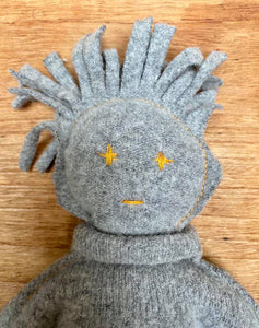 "The Disappointed One" character made of a grey pullover